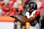 TAMPA, FL - DECEMBER 05:  Receiver Michael Jenkins #12 of the Atlanta Falcons catches a pass during warmups against the Tampa Bay Buccaneers at Raymond James Stadium on December 5, 2010 in Tampa, Florida.  (Photo by J. Meric/Getty Images)