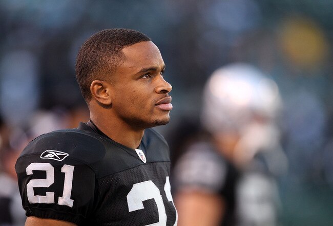 OAKLAND, CA - NOVEMBER 28:  Nnamdi Asomugha #21 of the Oakland Raiders stands on the sidelines during the closing minutes of their loss to the Miami Dolphins at Oakland-Alameda County Coliseum on November 28, 2010 in Oakland, California.  (Photo by Ezra Shaw/Getty Images)