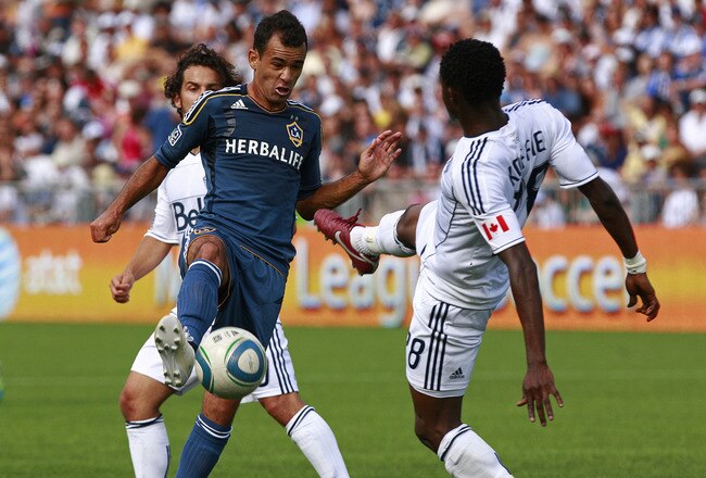 VANCOUVER, CANADA - JULY 30:  Juninho #19 of the Los Angeles Galaxy gains control of the ball against Gershon Koffie #28 of the Vancouver Whitecaps FC during their MLS game July 30, 2011 at Empire Field in Vancouver, British Columbia, Canada. (Photo by Jeff Vinnick/Getty Images)