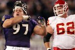 BALTIMORE - OCTOBER 4:  Kelly Gregg #97 of the Baltimore Ravens celebrates after tackling Priest Holmes of the Kansas City Chiefs while Casey Wiegmann #62 looks on, on October 4, 2004 at M&T Bank Stadium in Baltimore, Maryland.  (Photo by Doug Pensinger/Getty Images)