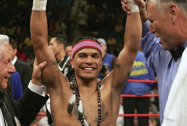 LAS VEGAS - JULY 15:  Daniel Ponce De Leon raises his arms after knocking out Sod Looknongyangtoy 52 seconds into the first round of their WBO junior featherweight world championship fight at the MGM Grand Garden Arena July 15, 2006 in Las Vegas, Nevada.  (Photo by Jed Jacobsohn/Getty Images)