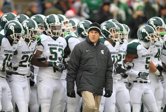 STATE COLLEGE, PA - NOVEMBER 27: Head coach Mark Dantonio of the Michigan State Spartans leads his team onto the field before a game against the Penn State Nittany Lions on November 27, 2010 at Beaver Stadium in State College, Pennsylvania. The Spartans won 28-22. (Photo by Hunter Martin/Getty Images)