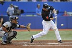 TORONTO, CANADA - JUNE 30:  Aaron Hill #2 of the Toronto Blue Jays bats in front of Michael McKenry #55 of the Pittsburgh Pirates during MLB interleague game action June 30, 2011 at Rogers Centre in Toronto, Ontario, Canada. (Photo by Brad White/Getty Images)