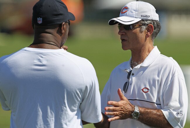BOURBONNAIS, IL - JULY 30:  General manager Jerry Angelo of the Chicago Bears (R) talks with head coach Lovie Smith during a summer training camp practice at Olivet Nazarene University on July 30, 2011 in Bourbonnais, Illinois.  (Photo by Jonathan Daniel/Getty Images)
