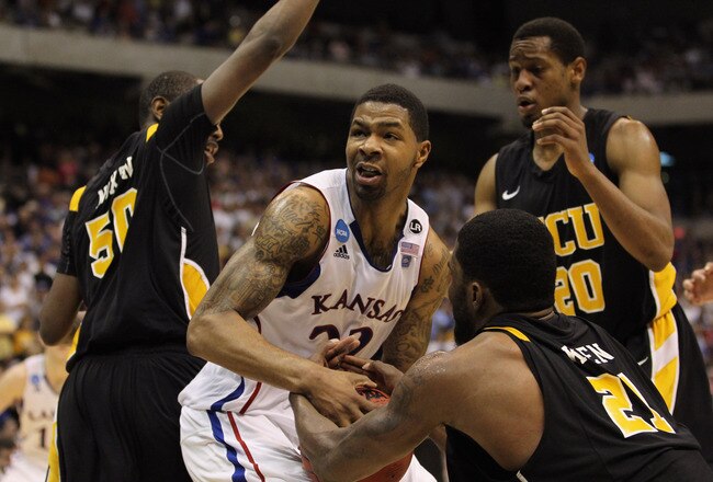 SAN ANTONIO, TX - MARCH 27:  Marcus Morris #22 of the Kansas Jayhawks handles the ball against Ed Nixon #50, Jamie Skeen #21 and Bradford Burgess #20 of the Virginia Commonwealth Rams during the southwest regional final of the 2011 NCAA men's basketball tournament at the Alamodome on March 27, 2011 in San Antonio, Texas. Virginia Commonwealth defeated Kansas 71-61. (Photo by Ronald Martinez/Getty Images)