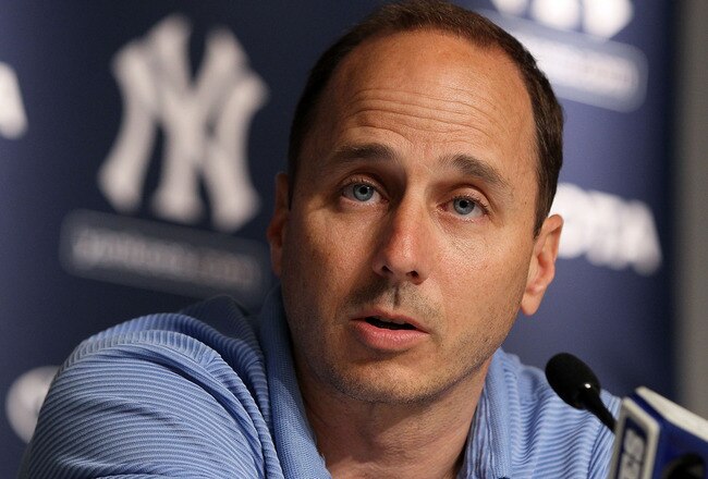 NEW YORK, NY - JULY 08:  General manager Brian Cashman of the New York Yankees speaks to the media after the game against the Tampa Bay Rays was postponed due to rain on July 8, 2011 at Yankee Stadium in the Bronx borough of New York City.  (Photo by Jim McIsaac/Getty Images)