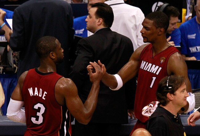 DALLAS, TX - JUNE 05:  Chris Bosh #1 (R) and Dwyane Wade #3 of the Miami Heat celebrate after the Heat won 88-86 against the Dallas Mavericks in Game Three of the 2011 NBA Finals at American Airlines Center on June 5, 2011 in Dallas, Texas.  NOTE TO USER: User expressly acknowledges and agrees that, by downloading and/or using this Photograph, user is consenting to the terms and conditions of the Getty Images License Agreement.  (Photo by Tom Pennington/Getty Images)