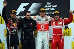 BUDAPEST, HUNGARY - JULY 31:  Race winner Jenson Button of Great Britain and McLaren celebrates on the podium with second placed Sebastian Vettel of Germany and Red Bull Racing and third placed Fernando Alonso of Spain and Ferrari following the Hungarian Formula One Grand Prix at the Hungaroring on July 31, 2011 in Budapest, Hungary.  (Photo by Lars Baron/Getty Images)