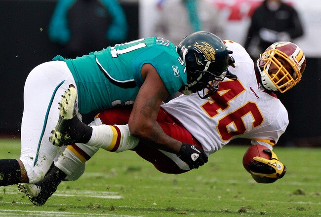 JACKSONVILLE, FL - DECEMBER 26:   Ryan Torain #46 of the Washington Redskins is tackled by Derrick Harvey #91 of the Jacksonville Jaguars during the game at EverBank Field on December 26, 2010 in Jacksonville, Florida.  (Photo by Sam Greenwood/Getty Images)