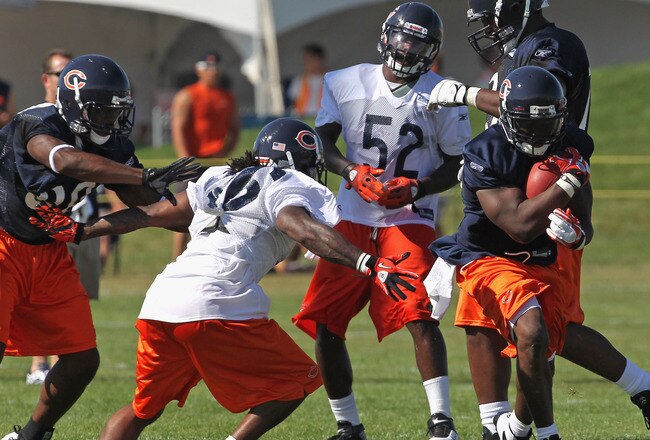 BOURBONNAIS, IL - JULY 30: Chester Taylor #29 of the Chicago Bears runs past Timm Jennings #26 during a summer training camp practice at Olivet Nazarene University on July 30, 2011 in Bourbonnais, Illinois. (Photo by Jonathan Daniel/Getty Images)