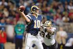 ST. LOUIS - NOVEMBER 15:  Quarterback Marc Bulger #10 of the St. Louis Rams looks to pass the ball against Charles Grant #94 of the New Orleans Saints at the Edward Jones Dome on November 15, 2009 in St. Louis, Missouri.  (Photo by Dilip Vishwanat/Getty Images)