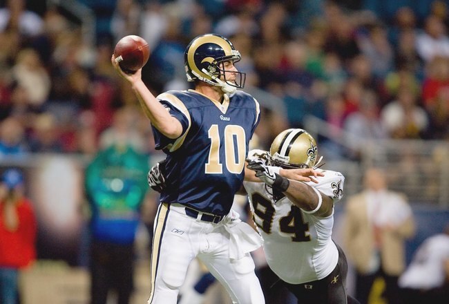 ST. LOUIS - NOVEMBER 15:  Quarterback Marc Bulger #10 of the St. Louis Rams looks to pass the ball against Charles Grant #94 of the New Orleans Saints at the Edward Jones Dome on November 15, 2009 in St. Louis, Missouri.  (Photo by Dilip Vishwanat/Getty Images)