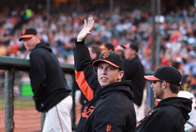 SAN FRANCISCO, CA - JULY 10:  Injured Buster Posey #28 of the San Francisco Giants waves to the crowd while sitting in the dugout during their game against the New York Mets at AT&T Park on July 10, 2011 in San Francisco, California.  (Photo by Ezra Shaw/Getty Images)