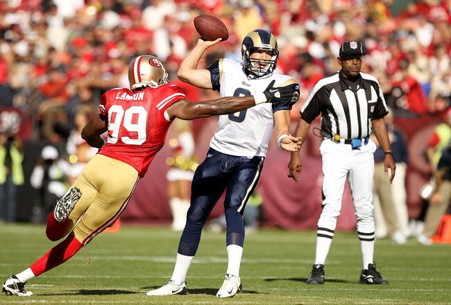 SAN FRANCISCO - NOVEMBER 14:  Sam Bradford #8  of the St. Louis Rams is hit by Manny Lawson #99 of the San Francisco 49ers at Candlestick Park on November 14, 2010 in San Francisco, California.  (Photo by Ezra Shaw/Getty Images)