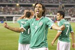 ARLINGTON, TX - JUNE 05:  Aldo De Nigris # 9 flanked Javier Hernandez #14 and Pablo Barrera #7 of Mexico celebrates a goal scored against El Salvador during the CONCACAF Gold Cup qualifying match at Cowboys Stadium on June 5, 2011 in Arlington, Texas.  (Photo by Rick Yeatts/Getty Images)