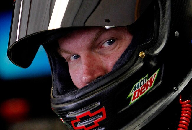 INDIANAPOLIS, IN - JULY 29:  Dale Earnhardt Jr., driver of the #88 Amp Energy/National Guard Chevrolet, stands in the garage during the practice for the NASCAR Sprint Cup Series Brickyard 400 at Indianapolis Motor Speedway on July 29, 2011 in Indianapolis, Indiana.  (Photo by Tom Pennington/Getty Images for NASCAR)