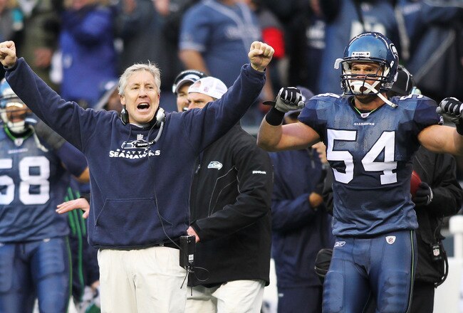 SEATTLE, WA - JANUARY 08: Head coach Pete Carroll and Will Herring #54 of the Seattle Seahawks celebrate a fourth down stop by the Seahawks in the third quarter against the New Orleans Saints during the 2011 NFC wild-card playoff game at Qwest Field on January 8, 2011 in Seattle, Washington. (Photo by Jonathan Ferrey/Getty Images)