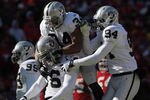 KANSAS CITY, MO - JANUARY 02: Oakland Raiders defensive players celebrate after stopping the Kansas City Chiefs during the game on January 2, 2011 at Arrowhead Stadium in Kansas City, Missouri.  (Photo by Jamie Squire/Getty Images)