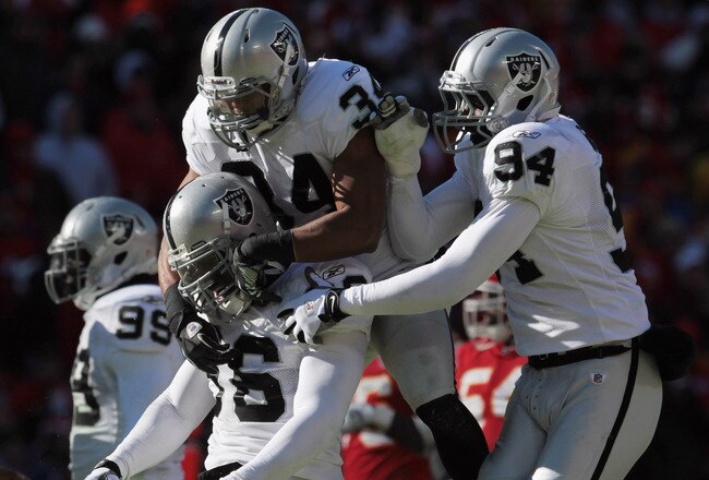 KANSAS CITY, MO - JANUARY 02: Oakland Raiders defensive players celebrate after stopping the Kansas City Chiefs during the game on January 2, 2011 at Arrowhead Stadium in Kansas City, Missouri.  (Photo by Jamie Squire/Getty Images)