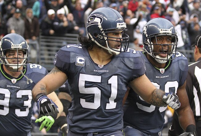 SEATTLE, WA - DECEMBER 05:  Linebacker Lofa Tatupu #51 of the Seattle Seahawks celebrates with Jay Richardson #99 and Craig Terrill #93 after returning an interception for a touchdown against the Carolina Panthers at Qwest Field on December 5, 2010 in Seattle, Washington. The Seahawks defeated the Panthers 31-14. (Photo by Otto Greule Jr/Getty Images)