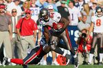 ORCHARD PARK, NY - SEPTEMBER 20:  Running back Cadillac Williams #24 of the Tampa Bay Buccaneers runs with the ball against Donte Whitner #20 of the Buffalo Bills during the game at Ralph Wilson Stadium on September 20, 2009 in Orchard Park, New York.  The Bills won 33-20.  (Photo by Rick Stewart/Getty Images)