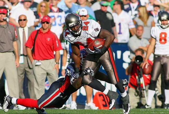 ORCHARD PARK, NY - SEPTEMBER 20:  Running back Cadillac Williams #24 of the Tampa Bay Buccaneers runs with the ball against Donte Whitner #20 of the Buffalo Bills during the game at Ralph Wilson Stadium on September 20, 2009 in Orchard Park, New York.  The Bills won 33-20.  (Photo by Rick Stewart/Getty Images)