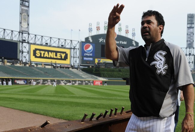 CHICAGO, IL - AUGUST 01: Ozzie Guillen #13 manager of the Chicago White Sox looks at an 8-foot steel I-beam from the World Trade Center wreckage on display during the Chicago White Sox and New York Yankees game on August 1, 2011 at U.S. Cellular Field in Chicago, Illinois. The beam will have permanent home in Darien, Illinois.  (Photo by David Banks/Getty Images)