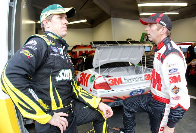 DAYTONA BEACH, FL - JUNE 30:  (L-R) Carl Edwards, driver of the #99 SUBWAY Ford, talks with teammate Greg Biffle, driver of the #16 3M Ford, during practice for the NASCAR Sprint Cup Series COKE ZERO 400 Powered by Coca-Cola at Daytona International Speedway on June 30, 2011 in Daytona Beach, Florida.  (Photo by Todd Warshaw/Getty Images for NASCAR)