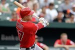BALTIMORE, MD - JULY 24: Mike Trout #27 of the Los Angeles Angels of Anaheim follows his three RBI home run against the Baltimore Orioles during the eighth inning at Oriole Park at Camden Yards on July 24, 2011 in Baltimore, Maryland. The Angels defeated the Orioles 9-3. (Photo by Rob Carr/Getty Images)
