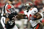 ATLANTA - NOVEMBER 29:  Cadillac Williams #24 of the Tampa Bay Buccaneers stiff arms Erik Coleman #26 of the Atlanta Falcons at Georgia Dome on November 29, 2009 in Atlanta, Georgia.  (Photo by Kevin C. Cox/Getty Images)