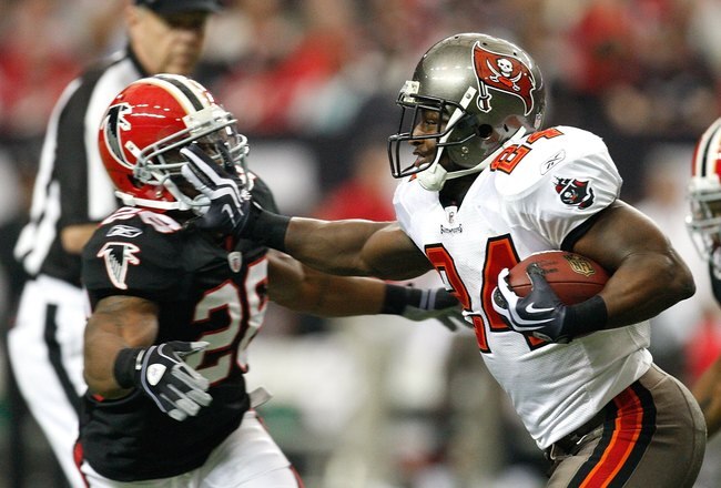 ATLANTA - NOVEMBER 29:  Cadillac Williams #24 of the Tampa Bay Buccaneers stiff arms Erik Coleman #26 of the Atlanta Falcons at Georgia Dome on November 29, 2009 in Atlanta, Georgia.  (Photo by Kevin C. Cox/Getty Images)