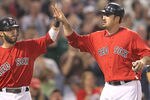 BOSTON, MA  - JUNE 17:  Dustin Pedroia #15 and Adrian Gonzalez #28 of the Boston Red Sox celebrate after they scored runs in the third inning on a hit by KevinYoukillis #20 against the Milwaukee Brewers at Fenway Park on June 17, 2011 in Boston, Massachusetts.  (Photo by Jim Rogash/Getty Images)