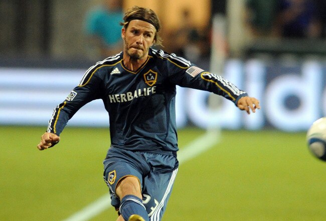 PORTLAND, OR - AUGUST 3: David Beckham #23 of the Los Angeles Galaxy passes the ball on Mike Chabala #4 of the Portland Timbers during the second half of the game at Jeld-Wen Field on August 3, 2011 in Portland, Oregon. The Timbers won the game 3-0. (Photo by Steve Dykes/Getty Images)