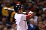 BOSTON, MA - MAY 22:  Jed Lowrie #12 of the Boston Red Sox hits an RBI single in the fourth inning against the Chicago Cubs on May 22, 2011 at Fenway Park in Boston, Massachusetts.  Before this series, the two teams haven't played at Fenway Park since the 1918 World Series.  (Photo by Elsa/Getty Images)