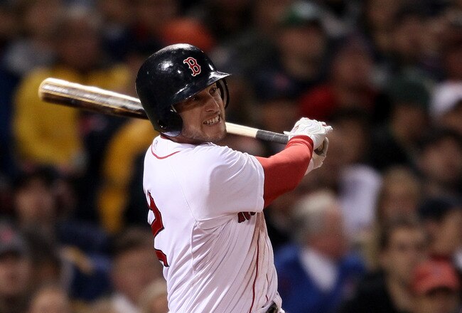 BOSTON, MA - MAY 22:  Jed Lowrie #12 of the Boston Red Sox hits an RBI single in the fourth inning against the Chicago Cubs on May 22, 2011 at Fenway Park in Boston, Massachusetts.  Before this series, the two teams haven't played at Fenway Park since the 1918 World Series.  (Photo by Elsa/Getty Images)