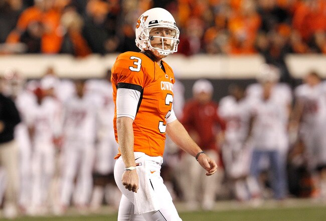 STILLWATER, OK - NOVEMBER 27:  Quarterback Brandon Weeden #3 of the Oklahoma State Cowboys walks off the field after failing to make a first down against the Oklahoma Sooners at Boone Pickens Stadium on November 27, 2010 in Stillwater, Oklahoma.  (Photo by Tom Pennington/Getty Images)