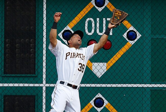 PITTSBURGH - AUGUST 04: Xavier Paul #38 of the Pittsburgh Pirates jumps up in the air along the warning track to catch a fly ball against the Chicago Cubs during the game on August 4, 2011 at PNC Park in Pittsburgh, Pennsylvania.  (Photo by Jared Wickerham/Getty Images)