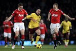 MANCHESTER, ENGLAND - DECEMBER 13:  Samir Nasri of Arsenal competes with Darren Fletcher (R) and Michael Carrick of Manchester United during the Barclays Premier League match between Manchester United and Arsenal at Old Trafford on December 13, 2010 in Manchester, England.  (Photo by Alex Livesey/Getty Images)