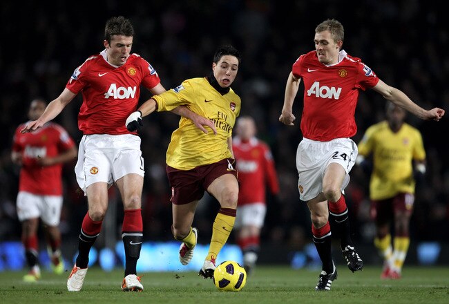 MANCHESTER, ENGLAND - DECEMBER 13:  Samir Nasri of Arsenal competes with Darren Fletcher (R) and Michael Carrick of Manchester United during the Barclays Premier League match between Manchester United and Arsenal at Old Trafford on December 13, 2010 in Manchester, England.  (Photo by Alex Livesey/Getty Images)