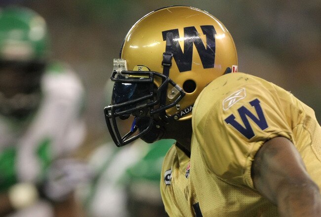 TORONTO, ON - NOVEMBER 25:  Charles Roberts #1 of the Winnipeg Blue Bombers rushes in front of Fred Perry #41 of the Saskatchewan Rough Riders during the third quarter of the 95th Grey Cup on November 25, 2007 at the Rogers Centre in Toronto, Ontario, Canada.  (Photo by Harry How/Getty Images)
