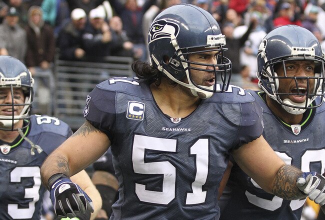 SEATTLE, WA - DECEMBER 05:  Linebacker Lofa Tatupu #51 of the Seattle Seahawks celebrates with Jay Richardson #99 and Craig Terrill #93 after returning an interception for a touchdown against the Carolina Panthers at Qwest Field on December 5, 2010 in Seattle, Washington. The Seahawks defeated the Panthers 31-14. (Photo by Otto Greule Jr/Getty Images)