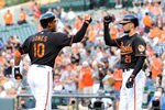BALTIMORE, MD - AUGUST 05:  Adam Jones #10 of the Baltimore Orioles celebrates with Nick Markakis #21 after hitting a home run in the first inning against the Toronto Blue Jays at Oriole Park at Camden Yards on August 5, 2011 in Baltimore, Maryland.  (Photo by Greg Fiume/Getty Images)