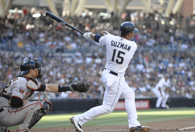 SAN DIEGO, CA - JULY 16:  Jesus Guzman #15 of the San Diego Padres hits a three-run homer during the first inning of a baseball game against the San Francisco Giants at Petco Park on July 16, 2011 in San Diego, California. (Photo by Denis Poroy/Getty Images)