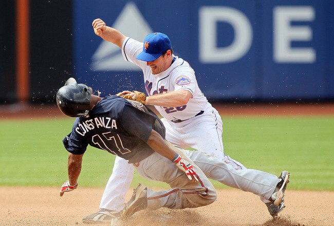 NEW YORK, NY - AUGUST 07:  Daniel Murphy #28 of the New York Mets is injured as Jose Constanza #17 of the Atlanta Braves steals second base in the seventh inning at Citi Field on August 7, 2011 in the Flushing neighborhood of the Queens borough of New York City.  (Photo by Jim McIsaac/Getty Images)