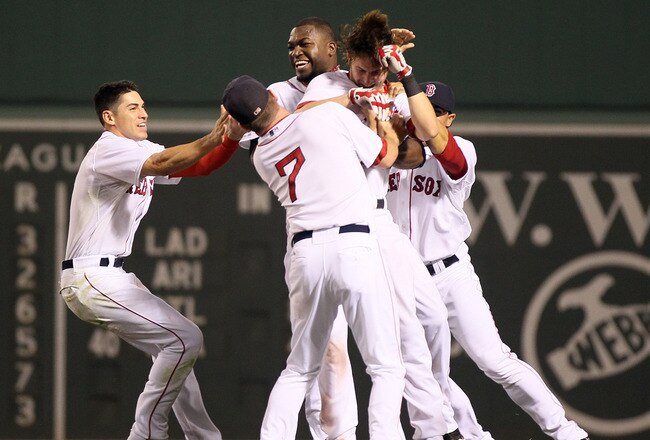 BOSTON, MA - AUGUST 08:  Josh Reddick #16 of the Boston Red Sox is surrounded by teammates Jacoby Ellsbury #2, J.D. Drew #7 Mike Aviles #3 and David Ortiz #34 after Reddick hit a walk off RBI single on August 8, 2011 at Fenway Park in Boston, Massachusetts.The Boston Red Sox defeated the New York Yankees 3-2 in 10 innings.  (Photo by Elsa/Getty Images)