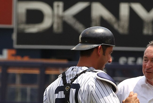 NEW YORK, NY - JUNE 26:  Head trainer Gene Monahan of the New York Yankees is met by Jorge Posada #20 during a retirement ceremony before the New York Yankees 65th Old Timers Day game on June 26, 2011 at Yankee Stadium in the Bronx borough of New York City.  (Photo by Al Bello/Getty Images)