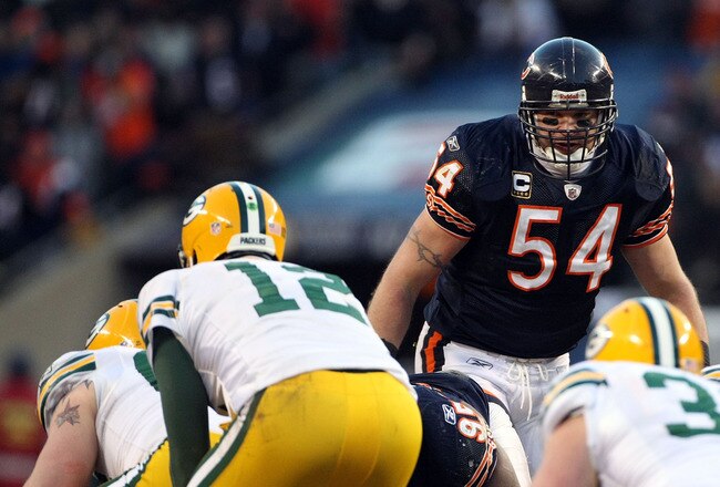 CHICAGO, IL - JANUARY 23:  Brian Urlacher #54 of the Chicago Bears looks over at Aaron Rodgers #12 of the Green Bay Packers before the snap in the NFC Championship Game at Soldier Field on January 23, 2011 in Chicago, Illinois.  (Photo by Doug Pensinger/Getty Images)