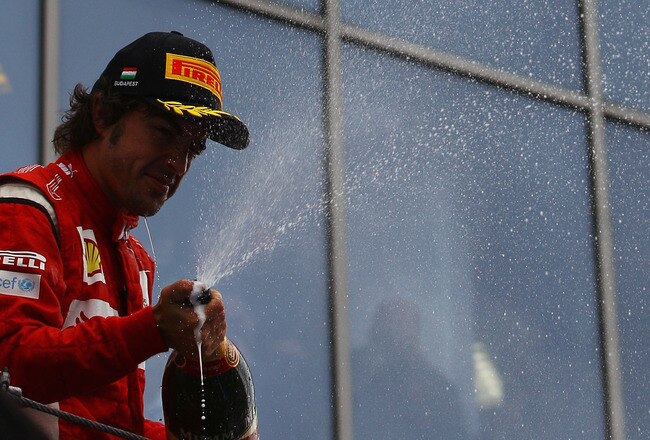 BUDAPEST, HUNGARY - JULY 31:  Third placed Fernando Alonso of Spain and Ferrari celebrates on the podium following the Hungarian Formula One Grand Prix at the Hungaroring on July 31, 2011 in Budapest, Hungary.  (Photo by Vladimir Rys/Getty Images)