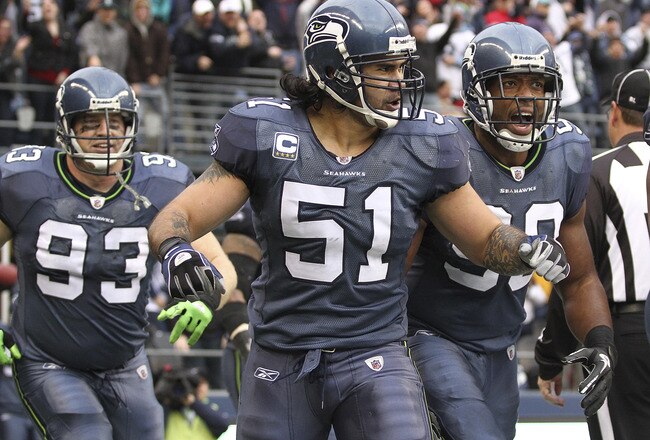 SEATTLE, WA - DECEMBER 05:  Linebacker Lofa Tatupu #51 of the Seattle Seahawks celebrates with Jay Richardson #99 and Craig Terrill #93 after returning an interception for a touchdown against the Carolina Panthers at Qwest Field on December 5, 2010 in Seattle, Washington. The Seahawks defeated the Panthers 31-14. (Photo by Otto Greule Jr/Getty Images)