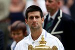 LONDON, ENGLAND - JULY 03:  Novak Djokovic of Serbia holds the championship trophy after winning his final round Gentlemen's match against Rafael Nadal of Spain on Day Thirteen of the Wimbledon Lawn Tennis Championships at the All England Lawn Tennis and Croquet Club on July 3, 2011 in London, England.  (Photo by Julian Finney/Getty Images)